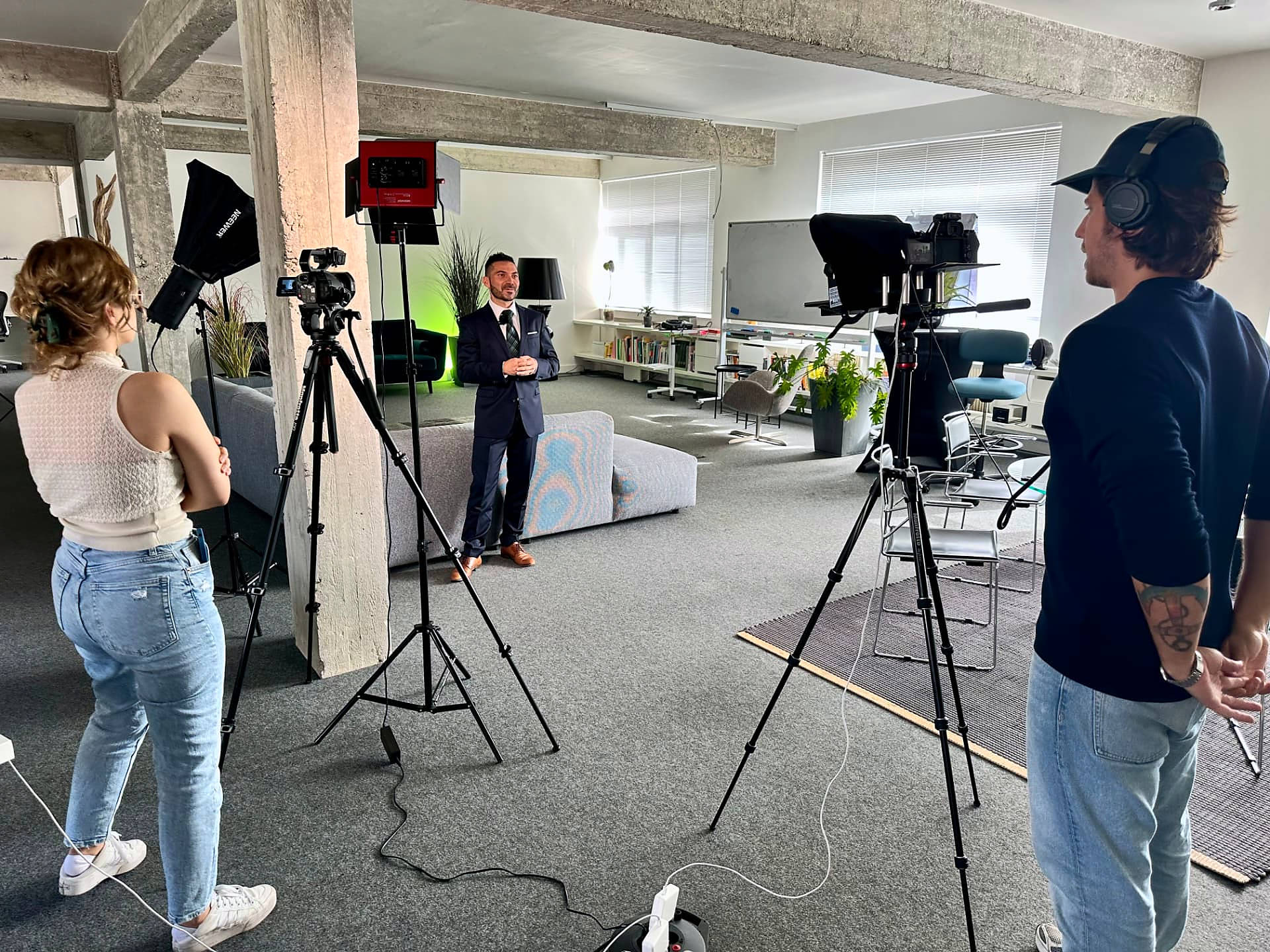 A two-camera video shoot in the #inextremis studio: a spokesperson to camera with crew, lighting and monitors around him