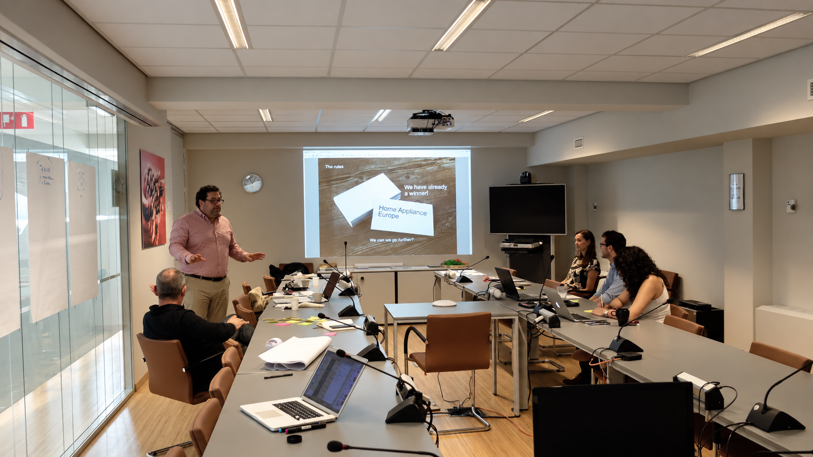 APPLiA brand strategy workshop: Alain Steinberg presenting naming work to the association team around a meeting table